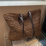 Woven carrier bag with leather straps