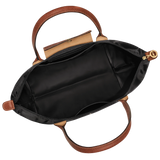 Black handbag with brown leather handles and strap on a white background
