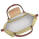 Beige handbag with brown handles and trim on a white background